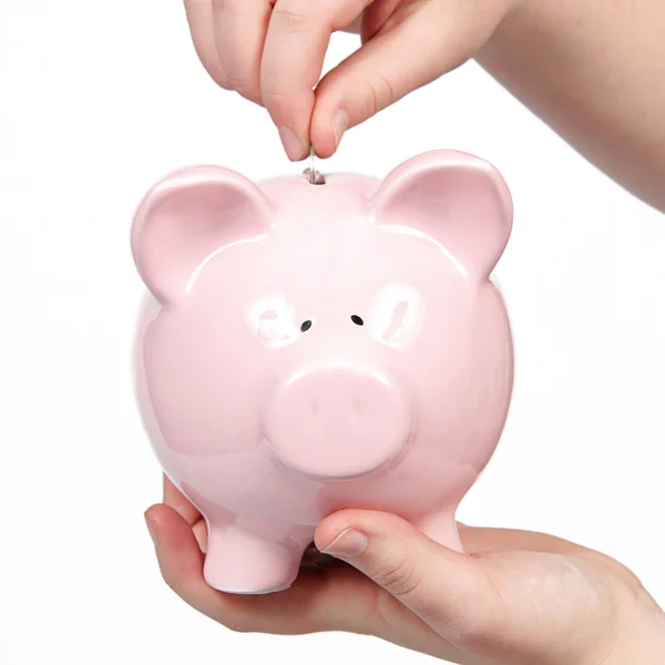 Hand zet munt in piggy bank — Stockfoto