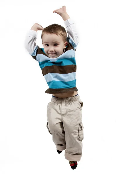 Happy little boy jumping in air — Stock Photo, Image