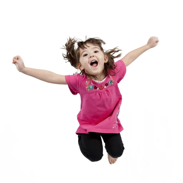Happy little girl jumping in air — Stock Photo, Image