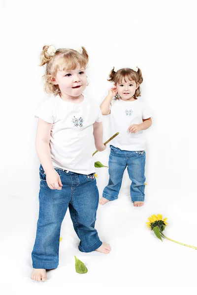 Little sisters with sunflowers — Stock Photo, Image