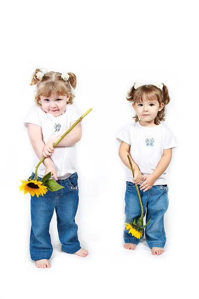 Małe siostry z słoneczniki — Zdjęcie stockowe