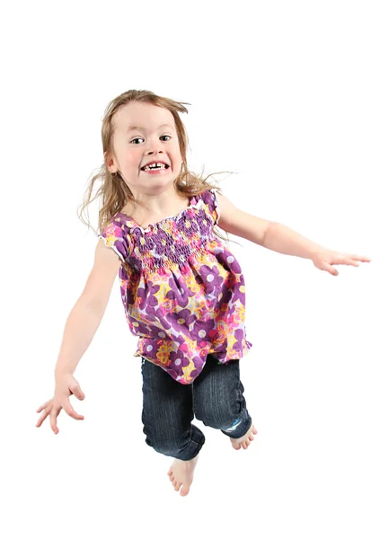 Happy little girl jumping in air — Stock Photo, Image