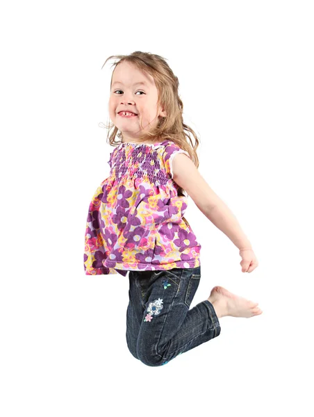 Happy little girl jumping in air — Stock Photo, Image