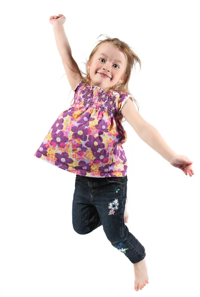 Happy little girl jumping in air — Stock Photo, Image