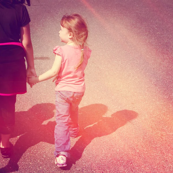 Little girl holding mother hand — Stock Photo, Image