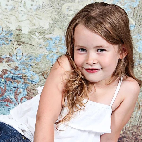 Little girl smiling in studio — Stock Photo, Image