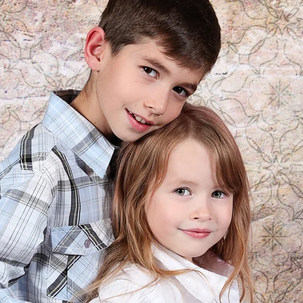 Little brother and Sister in studio Stock Picture