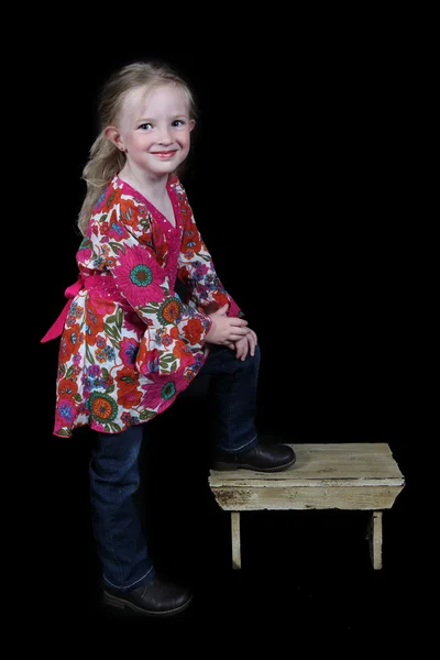 Kleines Mädchen steht auf Bank — Stockfoto