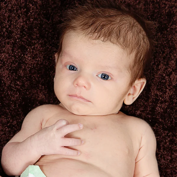 Newborn Baby on brown blanket — Stock Photo, Image