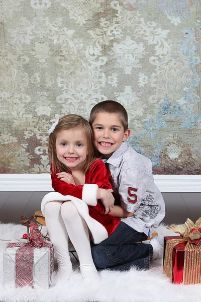 Sister with brother on  Christmas background — Stock Photo, Image