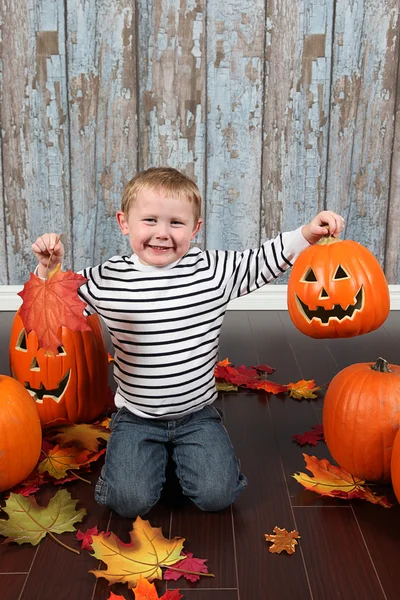 Cute little boy with pumpkins — Stock Photo, Image