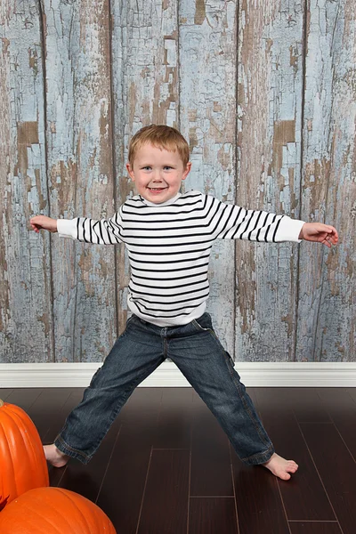 Cute little boy with pumpkins — Stock Photo, Image