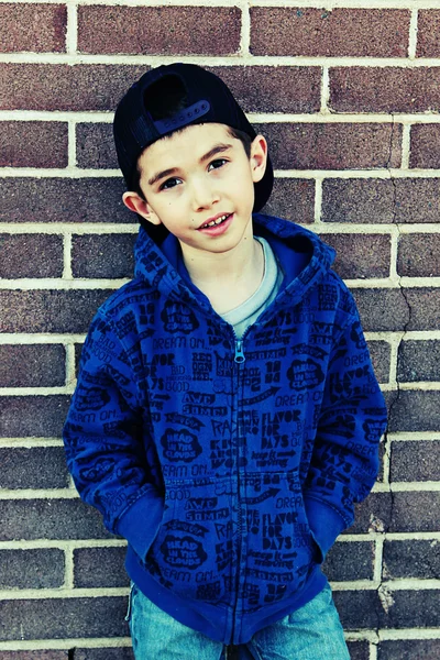 Boy posing on brick background — Stock Photo, Image