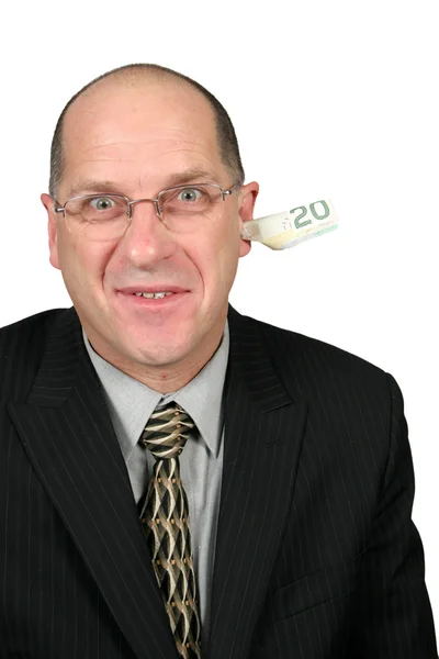 Бізнесмен з грошима з вуха — стокове фото