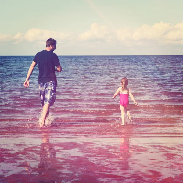 Pai e menina brincando na água — Fotografia de Stock