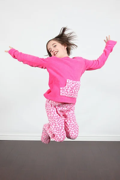 Little girl jumping in pajamas — Stock Photo, Image