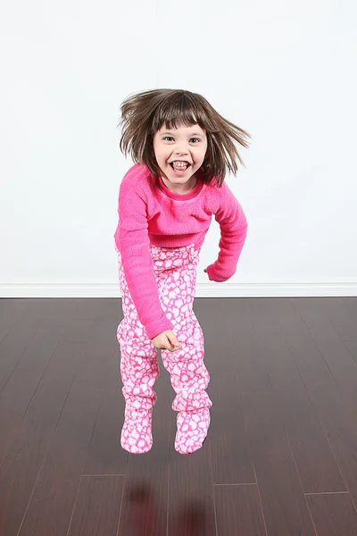 Little girl jumping in pajamas — Stock Photo, Image