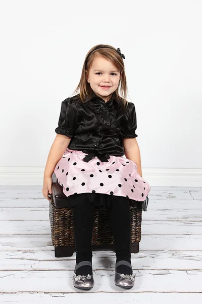 Little girl sitting in chair — Stock Photo, Image