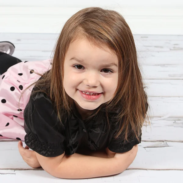 Little girl lying on floor — Stock Photo, Image