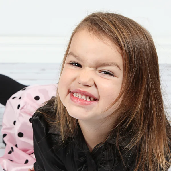 Little girl lying on floor — Stock Photo, Image