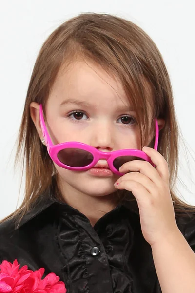Girl removes pink sunglasses — Stock Photo, Image