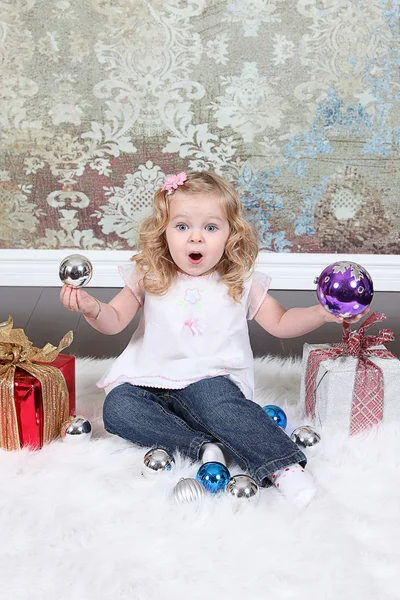 Little girl with gift boxes — Stock Photo, Image