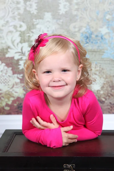 Little Girl leaning on vintage chest — Stock Photo, Image