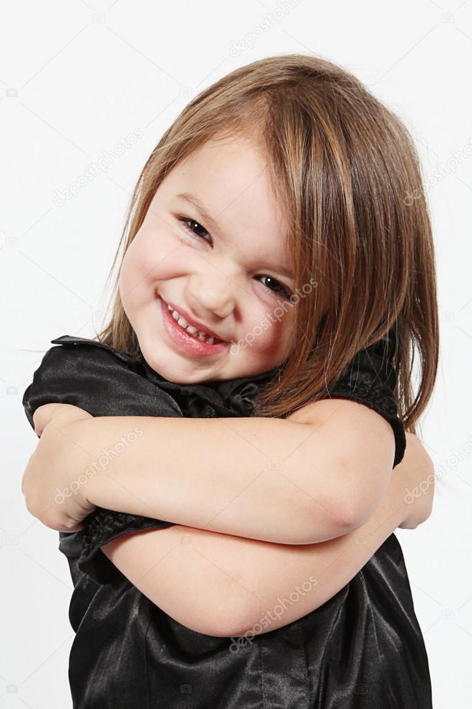 Little girl hugging herself