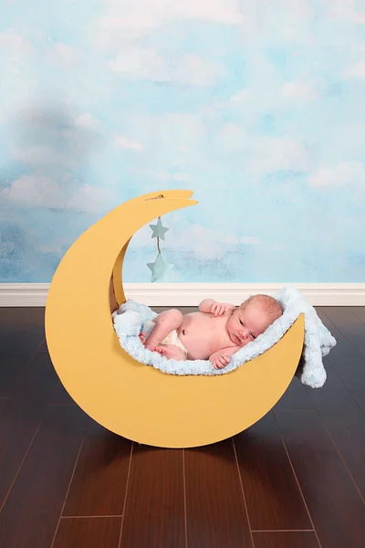 Baby boy in moon prop — Stock Photo, Image