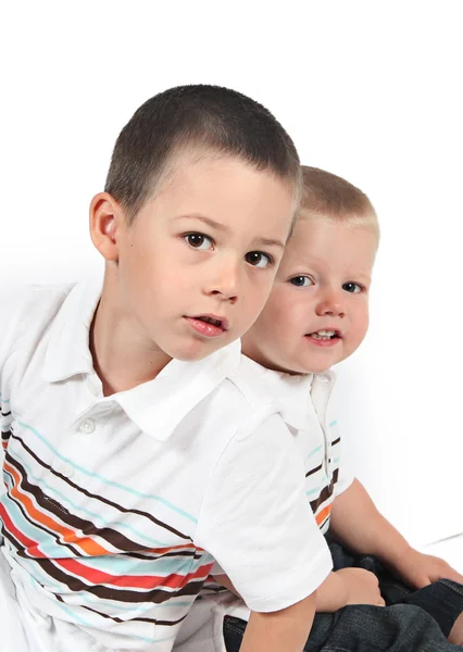 Brothers sitting together back to back — Stock Photo, Image