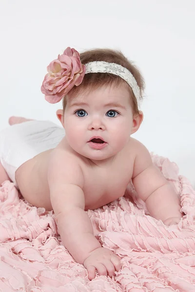 Baby girl on pink blanket — Stock Photo, Image