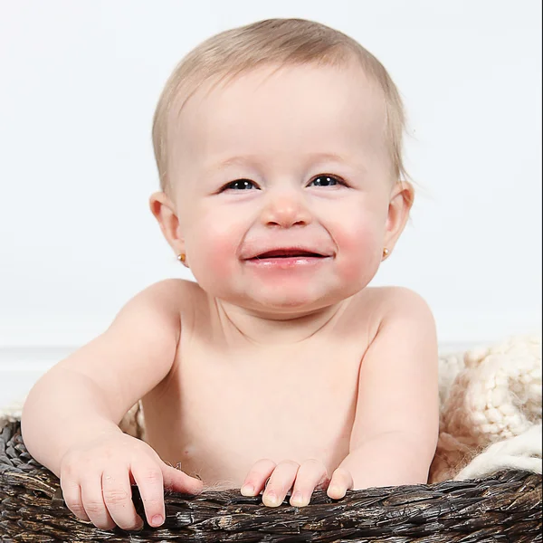 Adorable little sitting in basket — Stock Photo, Image