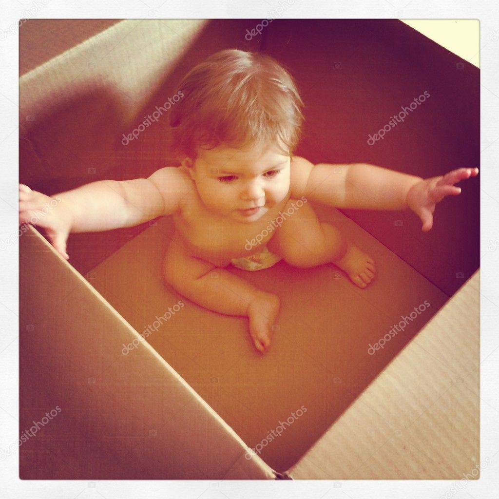 Little baby girl in shipping box