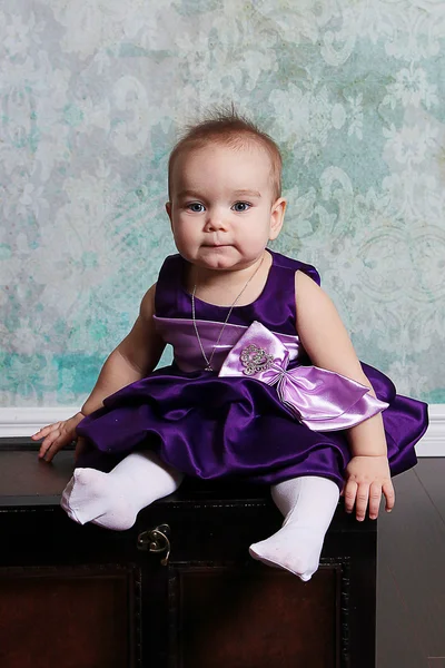 Little Girl sitting on vintage chest — Stock Photo, Image