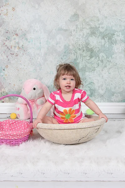 Beautiful Little Girl sitting in basket — Stock Photo, Image