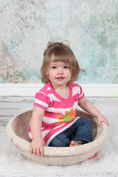 Beautiful Little Girl sitting in basket — Stock Photo, Image