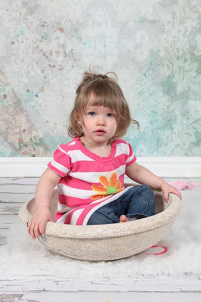 Beautiful Little Girl sitting in basket — Stock Photo, Image