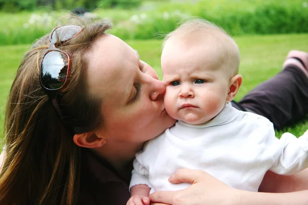 Mother and baby laying on grass — Stock Photo, Image