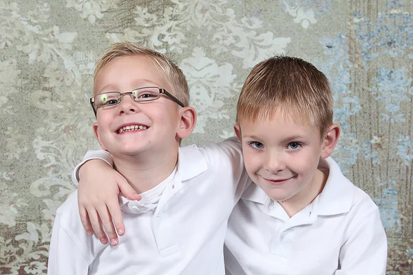 Little boys sitting in old empty room — Stock Photo, Image