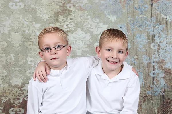 Little boys sitting in old empty room — Stock Photo, Image