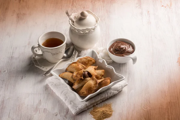 Xícara de chá e biscoito recheado com creme de chocolate — Fotografia de Stock