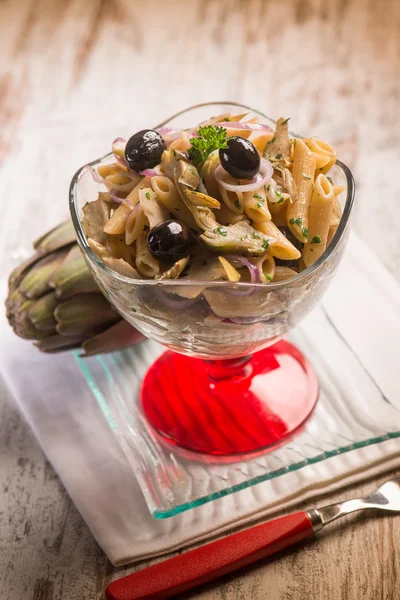 Pasta with artichoke and black olives, selective focus — Stock Photo, Image