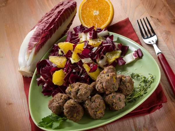 Meatball with red chicory and orange salad — Stock Photo, Image