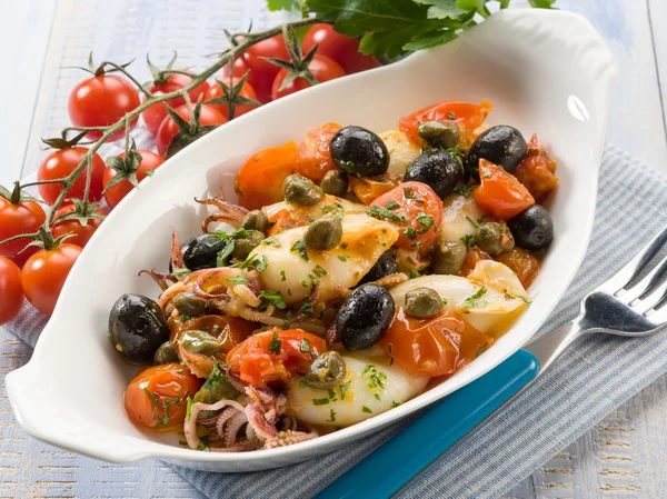 Squid with tomatoes olives and capers — Stock Photo, Image