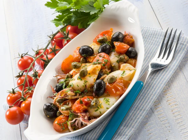 Squid with tomatoes olives and capers — Stock Photo, Image