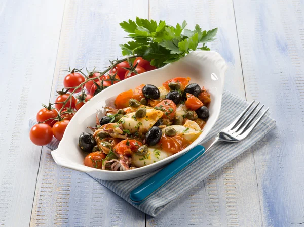 Squid with tomatoes olives and capers — Stock Photo, Image