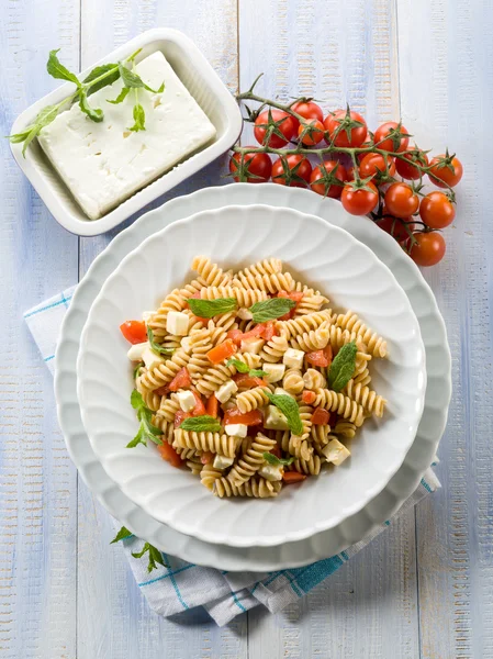 Pasta with feta cheese fresh tomatoes and mint leaf — Stock Photo, Image
