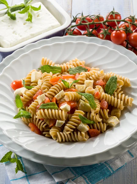 Pasta with feta cheese fresh tomatoes and mint leaf — Stock Photo, Image
