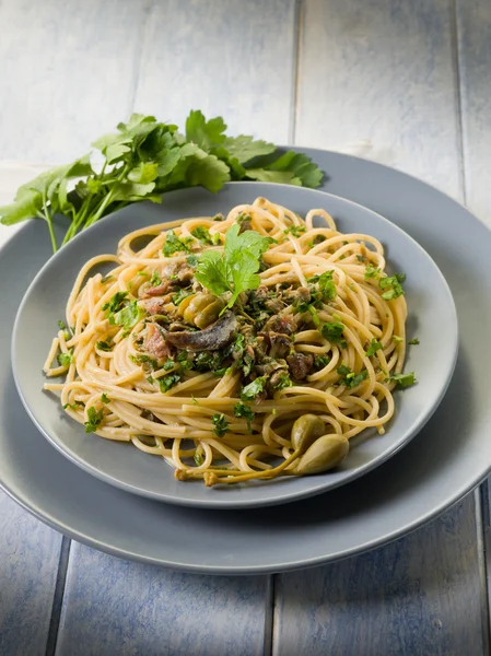 Spaghetti with anchovies parsley and capers — Stock Photo, Image