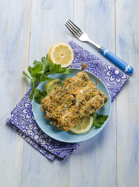 Breaded anchovies with lemon and parsley — Stock Photo, Image